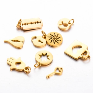 Detailed close-up of various gold titanium steel pendants including sun and heart shapes