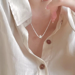 Elegant S925 sterling silver ball pendant necklace worn on a model in a minimal style