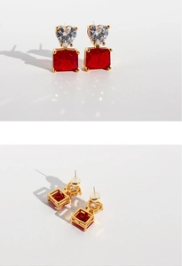 Detailed close-up showing gold heart zircon and red square gemstone earring components