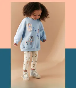 Detail view of sky blue fairy print sweatshirt and floral leggings on a young model