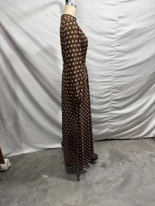 Side view of an elegant brown polka dot pleated maxi dress with long sleeves for women