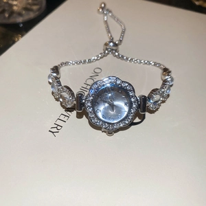Detail of floral rhinestone bezel watch with adjustable pull-chain crystal bracelet