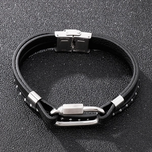 Detail of multi-layer black leather bracelet with stainless steel clasp and silver studs
