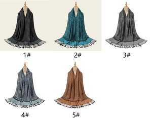 Detailed view of paisley patterns and delicate fringes on five acrylic pashmina scarves