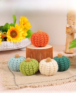 Set of five handmade knitted pumpkins in assorted colors for cozy autumn home decor