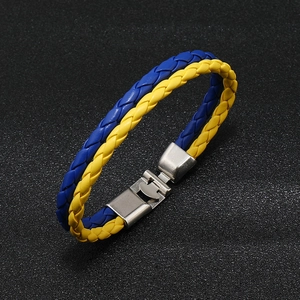 Blue and yellow braided leather bracelet with a silver magnetic metal clasp on black surface