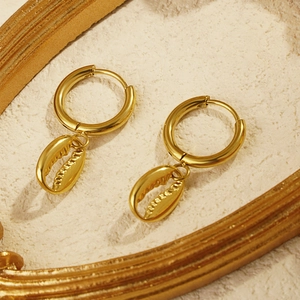Golden stainless steel hoop earrings with cowrie shell pendants in beach ocean style
