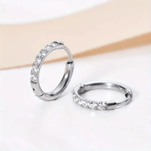 Elegant silver-colored hoop earrings with sparkling cubic zirconia pavé setting on white