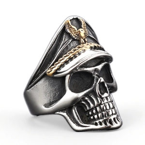 Punk skull ring with vintage silver finish and golden navy cap emblem details