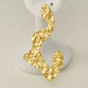 Irregular textured gold wave earrings in 304 stainless steel on a white jewelry stand