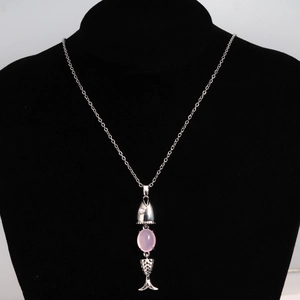 Detail of silver fish necklace featuring a movable body and a pink oval gemstone