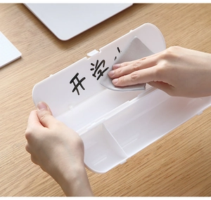Detail of white plastic pencil case featuring dual compartments and erasable surface