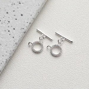 Detailed view of polished 14K gold-plated OT toggle clasps with sparkling CZ stones for DIY jewelry