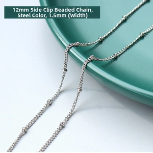 Detail of 1.5mm silver stainless steel bead chain necklace on a ceramic dish