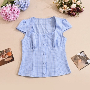 Detailed flat lay of blue checkered short sleeve blouse with square neck and buttons