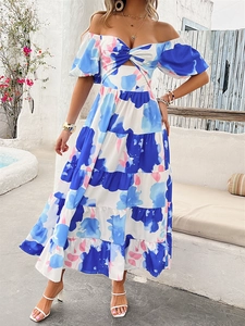 Dettaglio del vestito maxi a fiori con spalle scoperte, vita stretta e gonna a balze