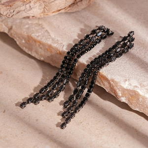 Détail de boucles d'oreilles noires à pampilles avec cristaux de zircon chic