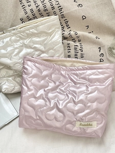 Quilted heart PU leather cosmetic pouch in white and pink with metal zipper closure