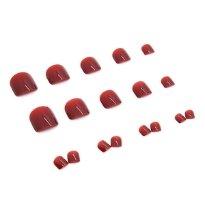 Glossy burgundy press-on toenails in 24-piece set showing various sizes on white background