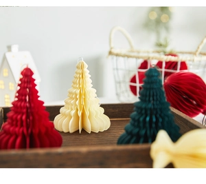 Close-up of 10cm red, cream, and green honeycomb paper Christmas tree ornaments