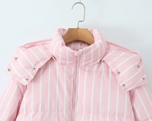 Detailed close-up of pink and white striped hooded puffer jacket with quilted texture