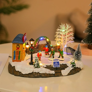 Animated Christmas village ice hockey scene with warm LED lights and resin figurines