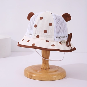 Detailed view of the breathable mesh crown and cute polka dot fabric on the baby sun hat
