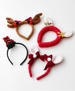 Set of four plush Christmas headbands with reindeer antlers and festive velvet textures