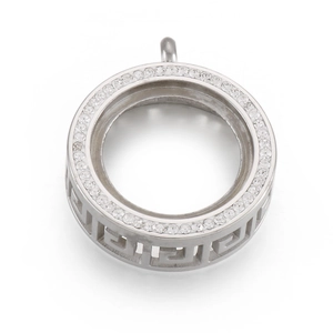 Macro view of silver circular pendant with sparkling cubic zirconia and Greek key cutout