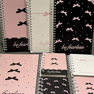 Detailed grid of pink and black A5 spiral notebooks with ribbon and fearless slogan
