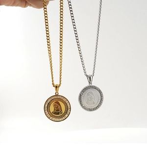 Macro view of gold and silver circular pendants with portrait and crystal inlay