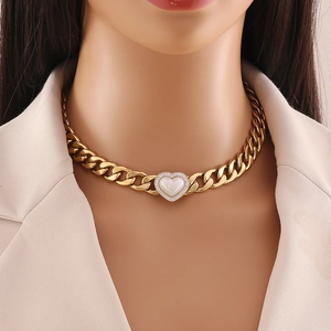 Golden chunky chain necklace featuring a heart pendant with small diamonds and white inlay