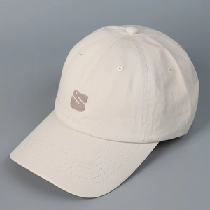 Close-up of beige cotton twill baseball cap with detailed brown S logo embroidery