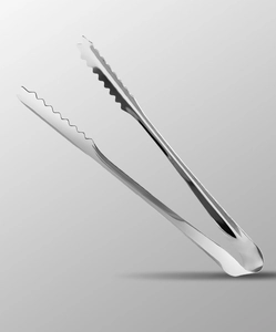 Close-up of stainless steel ice tongs featuring a serrated wave edge and polished finish