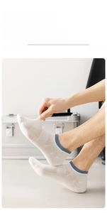 Detail of white mesh breathable ankle sock showing elastic cuff and fabric stretch