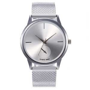 Macro detail of silver quartz watch with mesh strap and sunray brushed dial texture