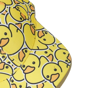 Close-up of duck pattern stitching and woven texture on a yellow baseball cap