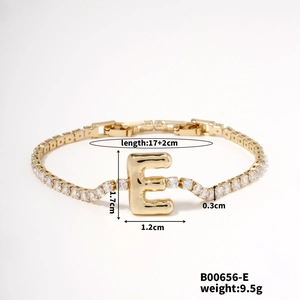 Detailed view of gold letter E bracelet with cubic zirconia and exact product dimensions
