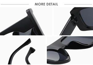 Detail of oversized black square sunglasses showing metal hinges and curved nose pads