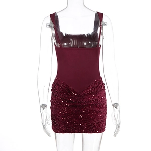 Detail of burgundy sequin hem and textured fabric on slim-fit cocktail party dress