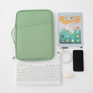Slim green iPad sleeve bag with handle and accessories on white background