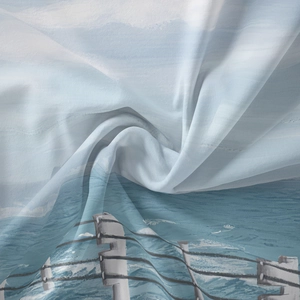 Detail of bohemian tapestry featuring ocean landscape print on lightweight textile fabric