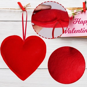 Detailed view of red felt heart ornaments with stitching and hanging strings for Valentine decor