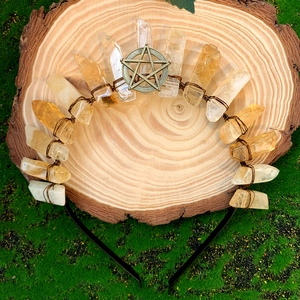 Handmade golden crystal crown headband with star charm on natural wood and moss background