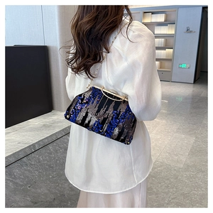 Chic black sequin evening bag with blue and silver patterns shown on model shoulder