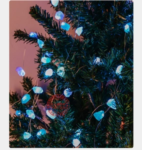 Blue natural crystal LED string lights wrapped around green pine branches for Christmas decor
