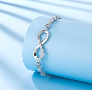 Detailed macro view of silver infinity bracelet with small sparkling cubic zirconia stones