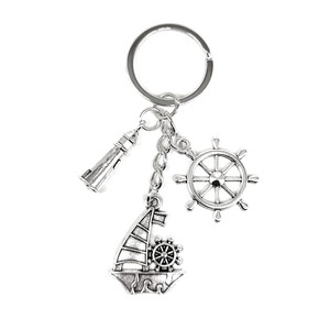 Nautical keychain featuring lighthouse, ship wheel, and vintage sailing boat charms