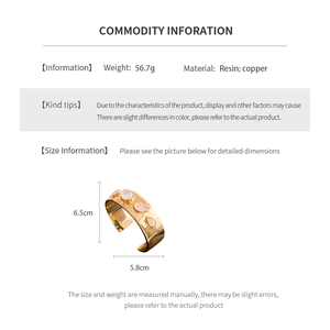 Detailed view of 18K gold plated drop-shaped resin bangle with size and weight metrics