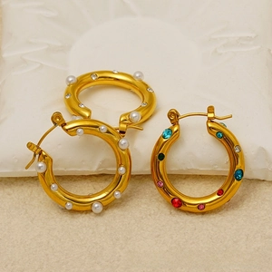 Close-up of 18k gold-plated chunky hoop earrings featuring white pearls and colorful zircons
